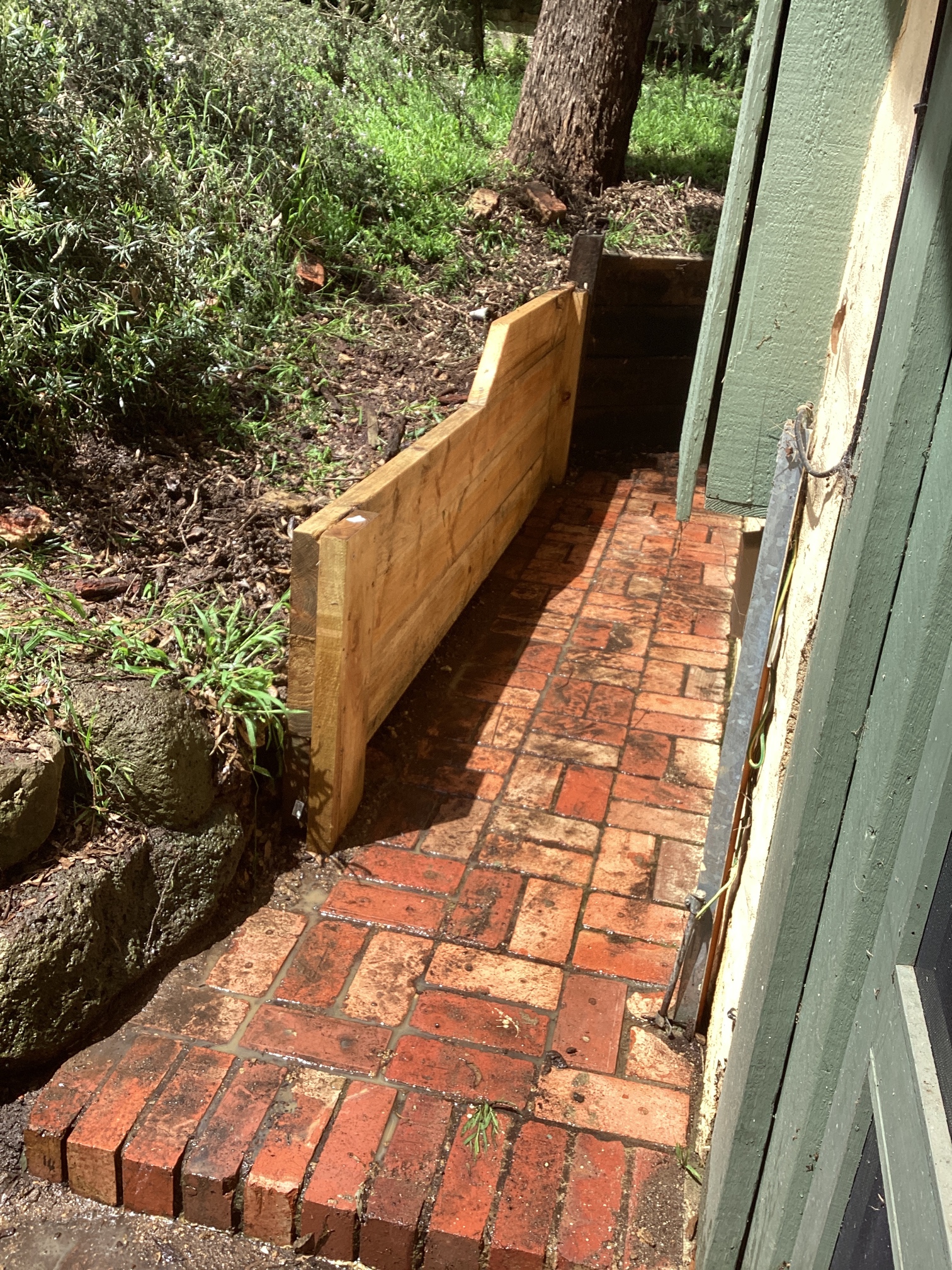 Retaining wall construction and timber sleeper installation